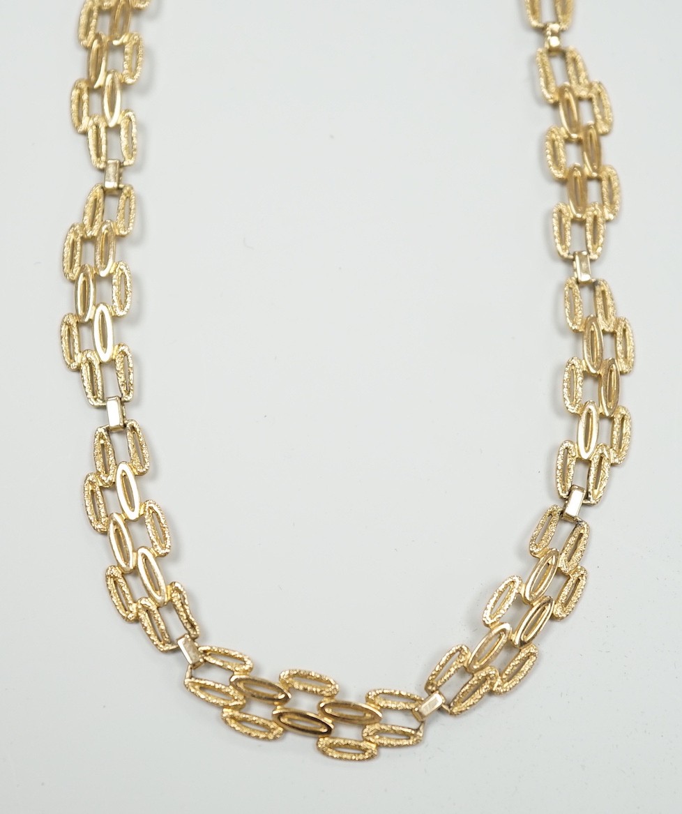 A 9ct gold pierced fancy link necklace, 45cm, 11 grams.